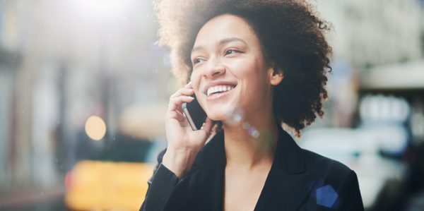 Smiling woman talking to customer service on phone