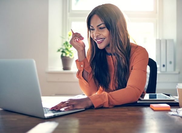 Business woman booking travel on laptop