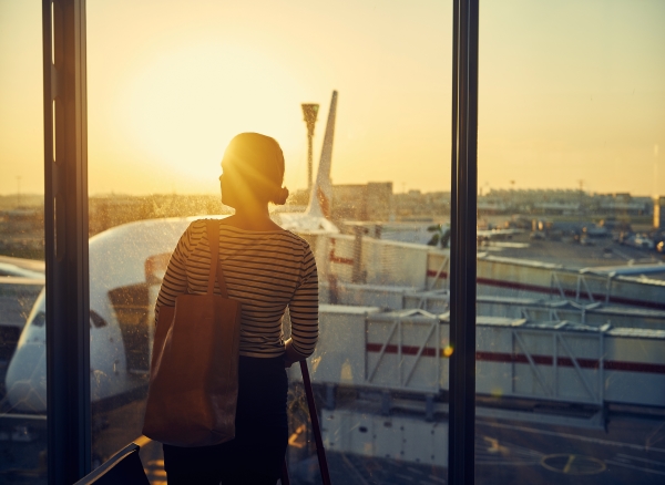 Business traveler at airport terminal at sunset