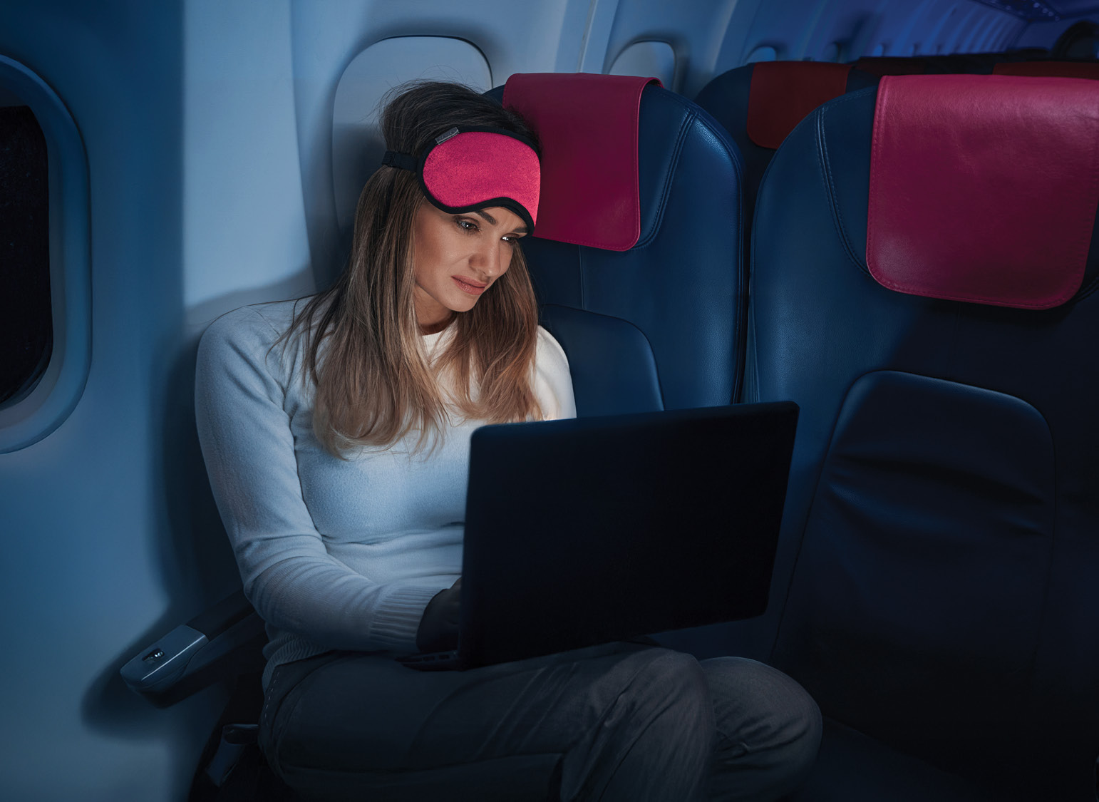 Business traveler inflight with her eye mask on