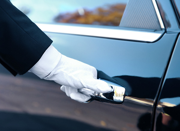 White glove concierge opening car door