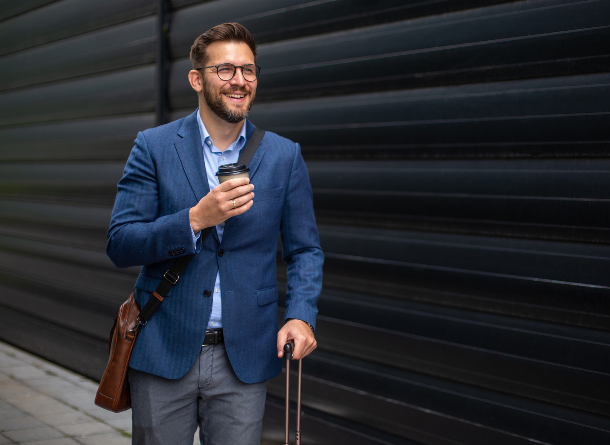 Smiling traveler walking with suitcase